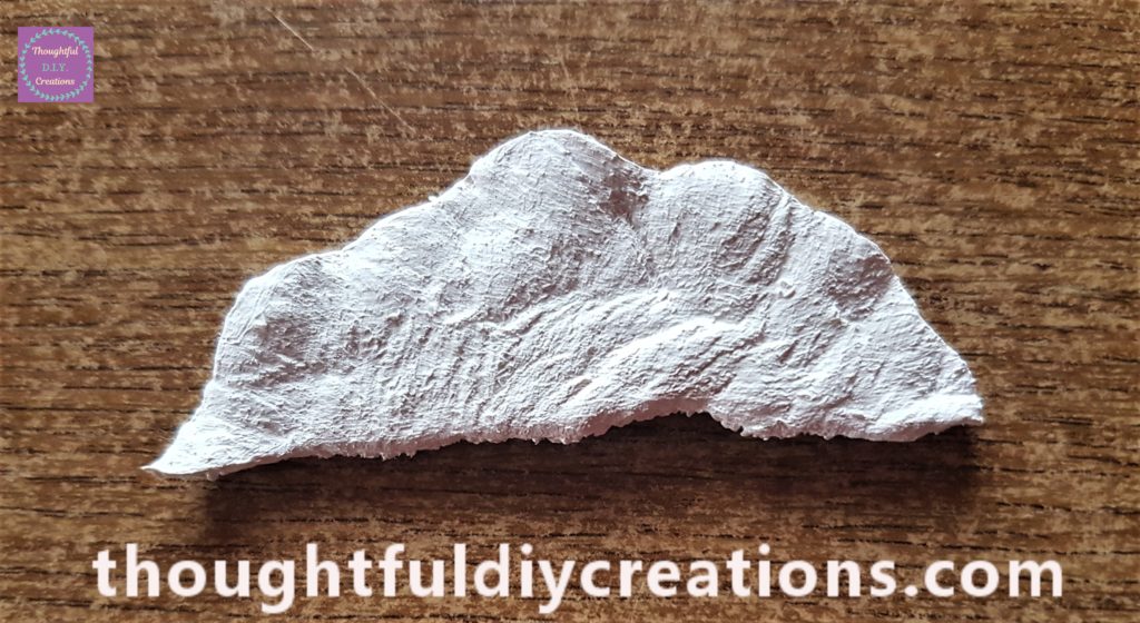 Cloud that I made out of a fluffy bed sock, gesso and white acrylic paint.