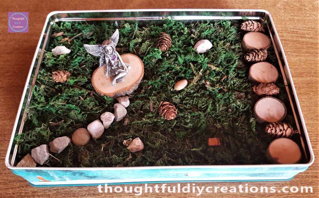 A few more pine cones and stones added to the fairy garden.
