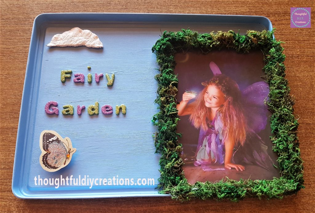 Hot glue on the back of the last square and attached the butterfly to the lid.