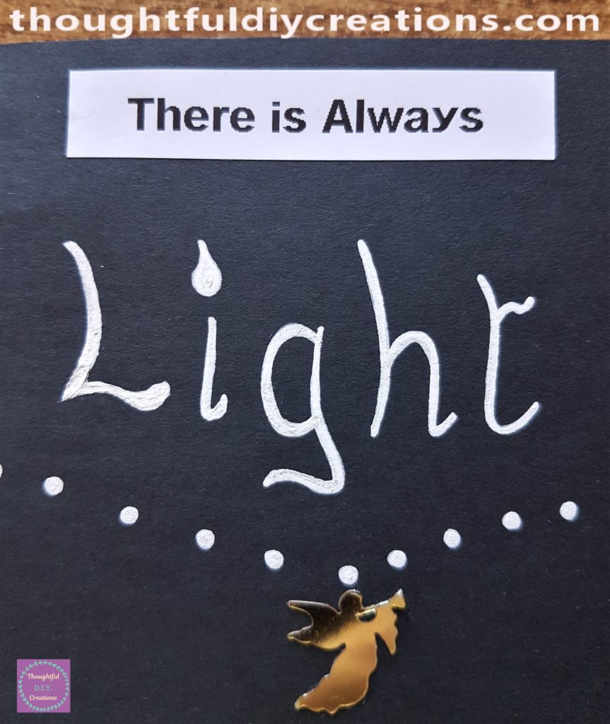 The 'There is Always' print-out adhered to the top of the Art Journal. The word 'Light' wrote underneath the label using the white paint pen.