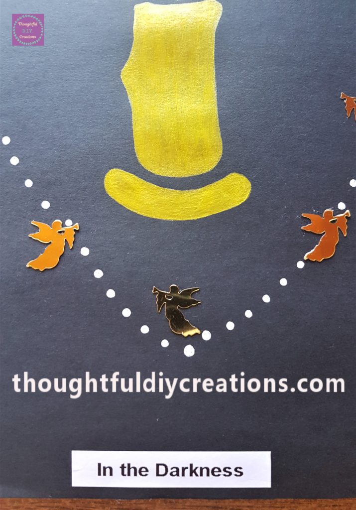 The backing removed from 'In the Darkness' print-out and adhered to the bottom of the page.