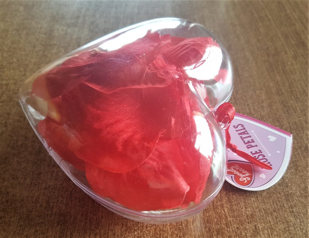 Plastic Heart with Rose Petals inside.