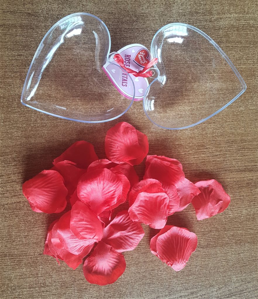 The plastic heart opened up with the rose petals removed.