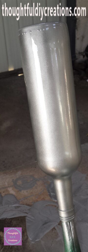 One even coat of spray paint on the wine bottle.