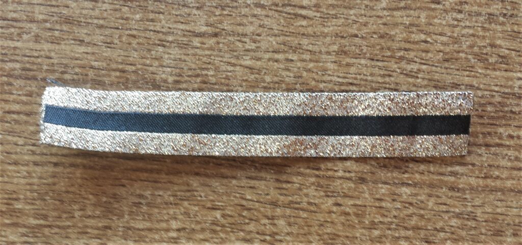 Black and Gold Ribbon cut to fit around the lid of the Bottle.