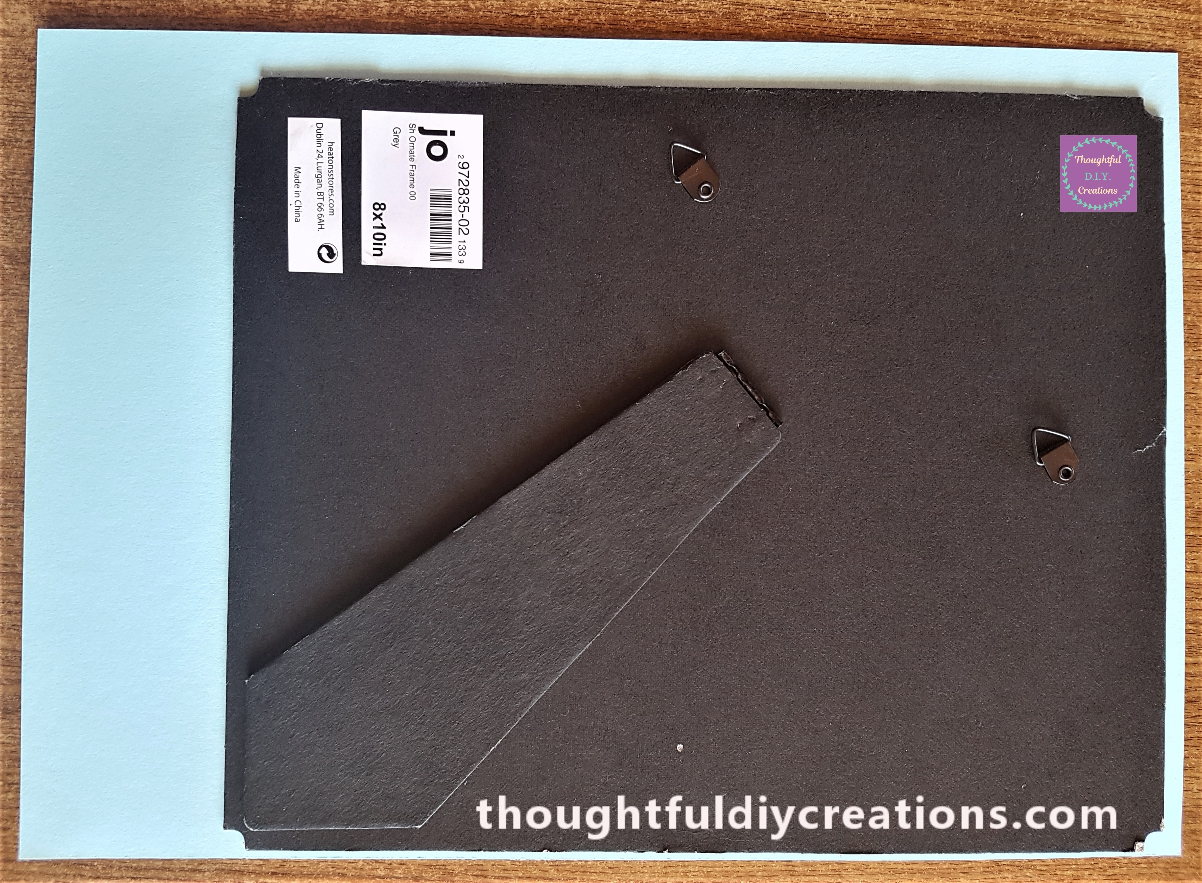 Pritt Stick all over the grey backing of the frame, blue card pressed to the grey backing.