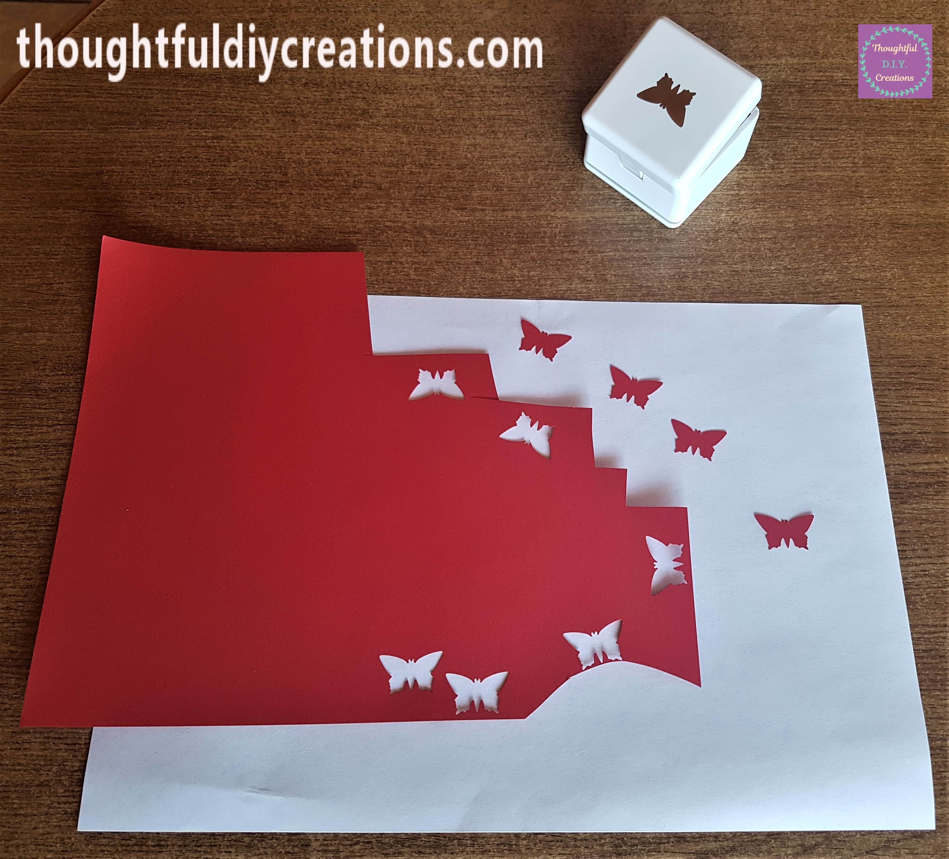Butterflies punched out using red paper and the punch.