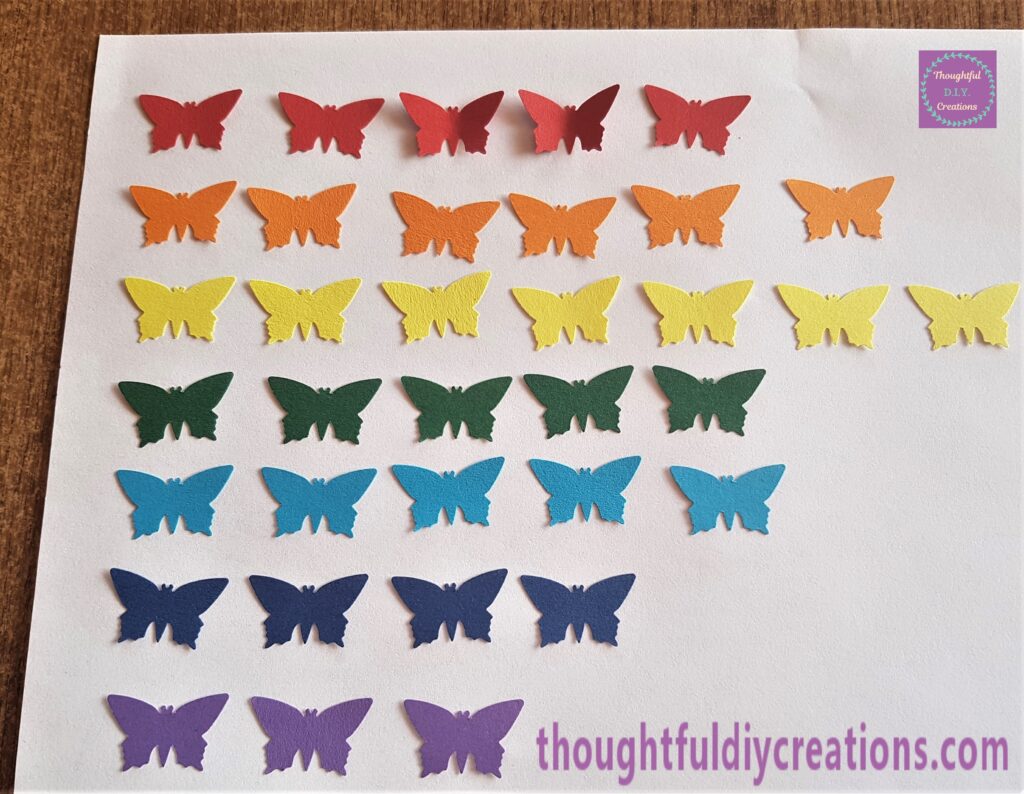 All the colours of the rainbow punched out as butterflies.