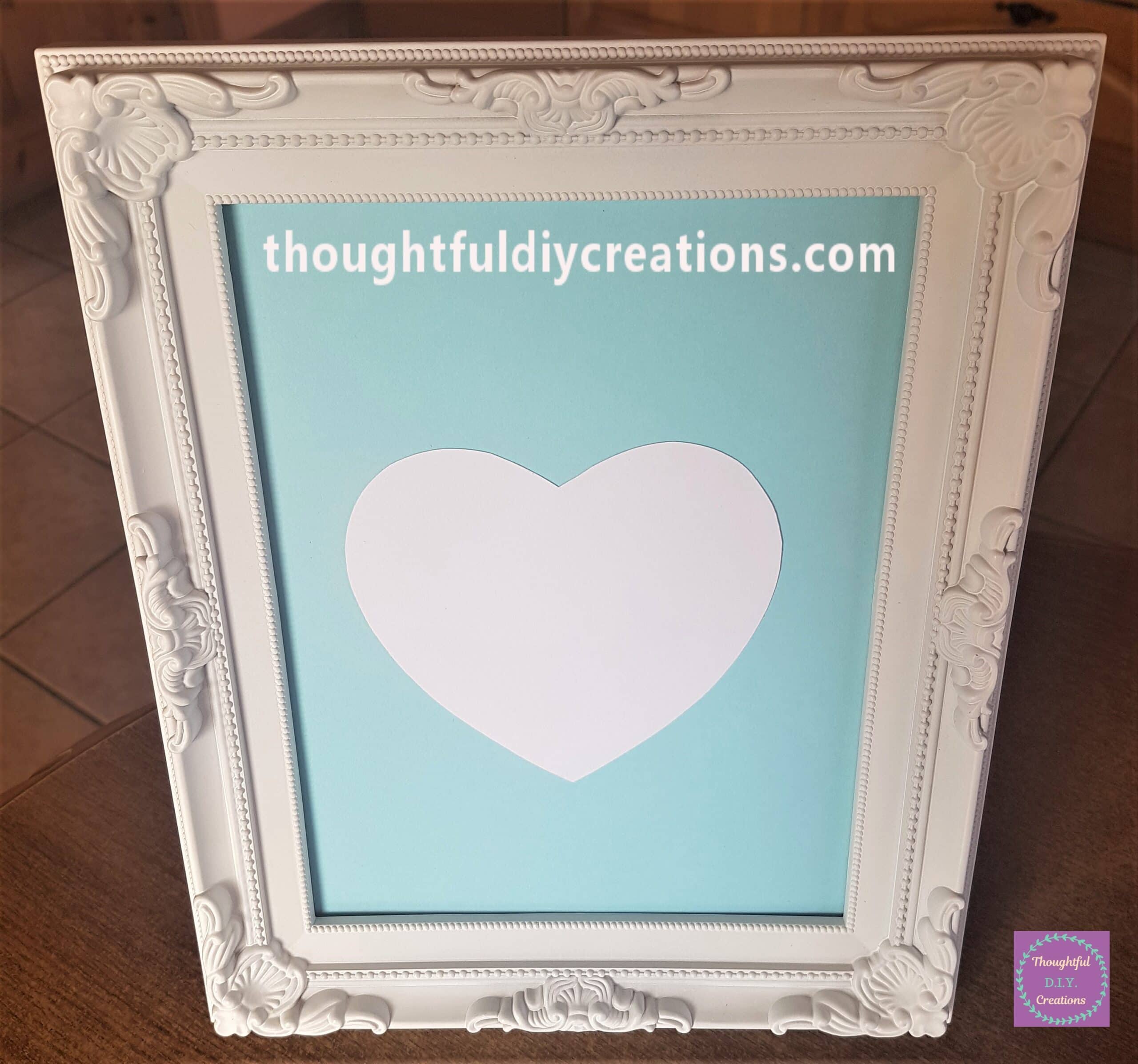 Pritt Stick on the back of the heart and attached to the frame.