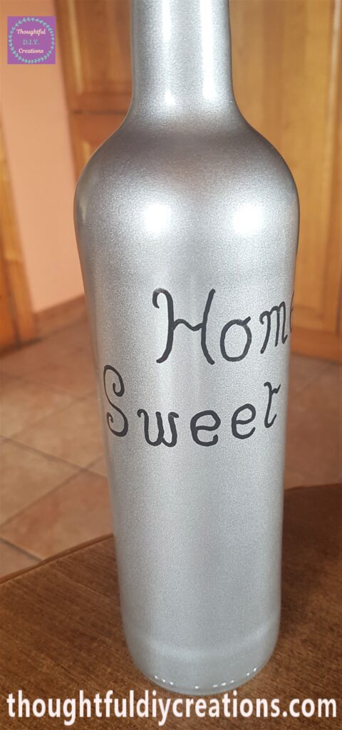 The word 'Sweet' written under the word 'Home' with the paint marker.