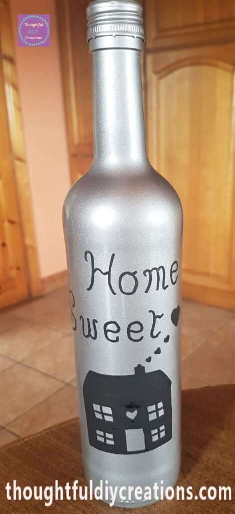 The love hearts, chimney, roof, and house filled in with the black paint marker.