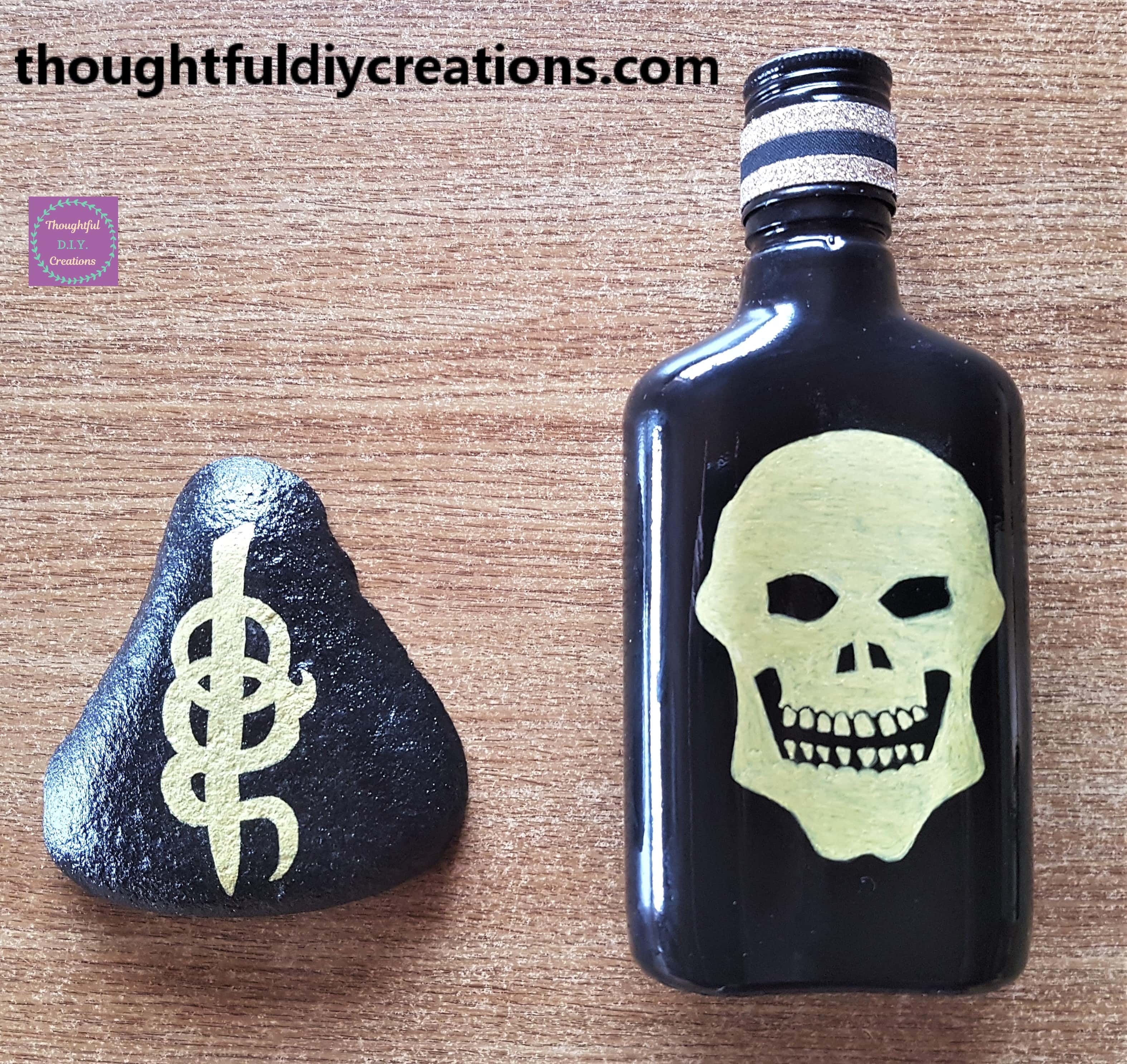 Re-purposed bottle laying flat beside the re-purposed stone.