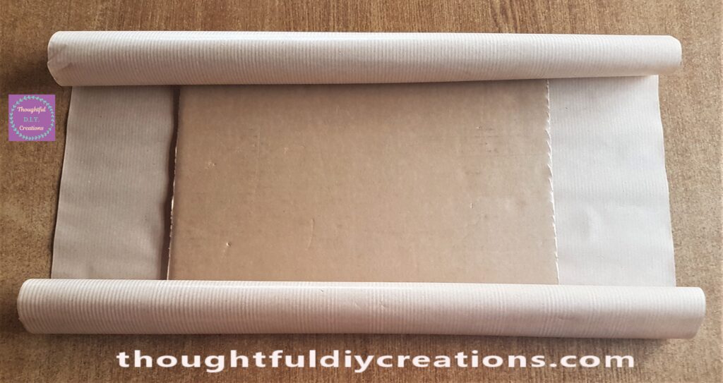 Brown Paper cut to fit the Cardboard Base front and back.