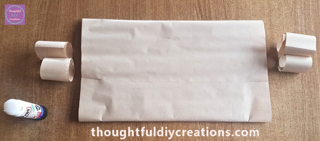 Pritt Stick along 1 edge of the brown paper and attached to the other edge on the back of the cardboard.