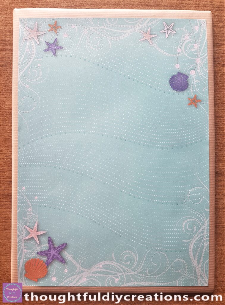 Pritt Stick on the back of the Beach Page and attached to the Brown Papered Cardboard Base.