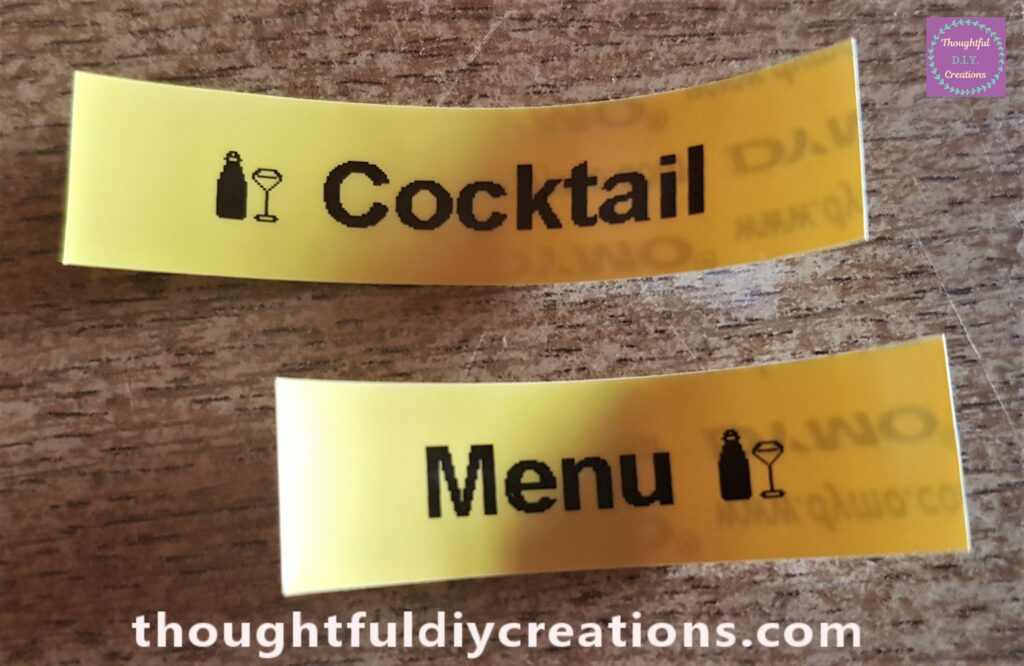 The words 'Cocktail' and 'Menu' printed from the Label Maker and Yellow Plastic Tape Roll.