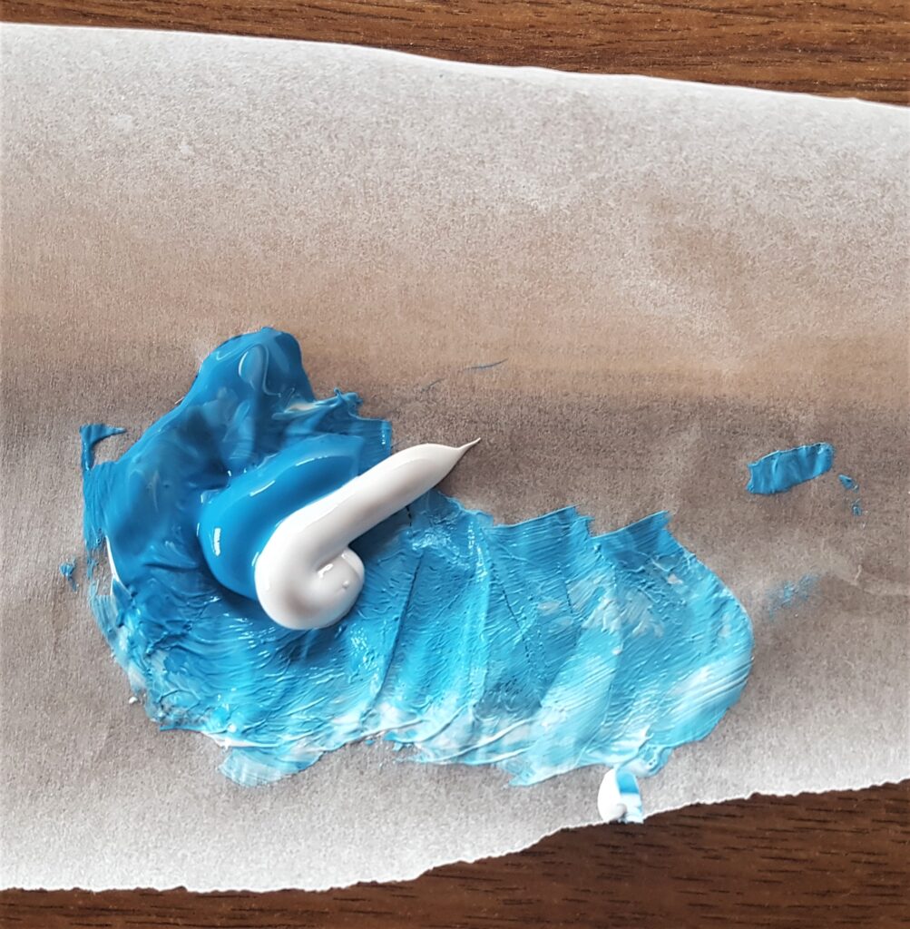 Blue and White Paint on Baking Parchment Paper.