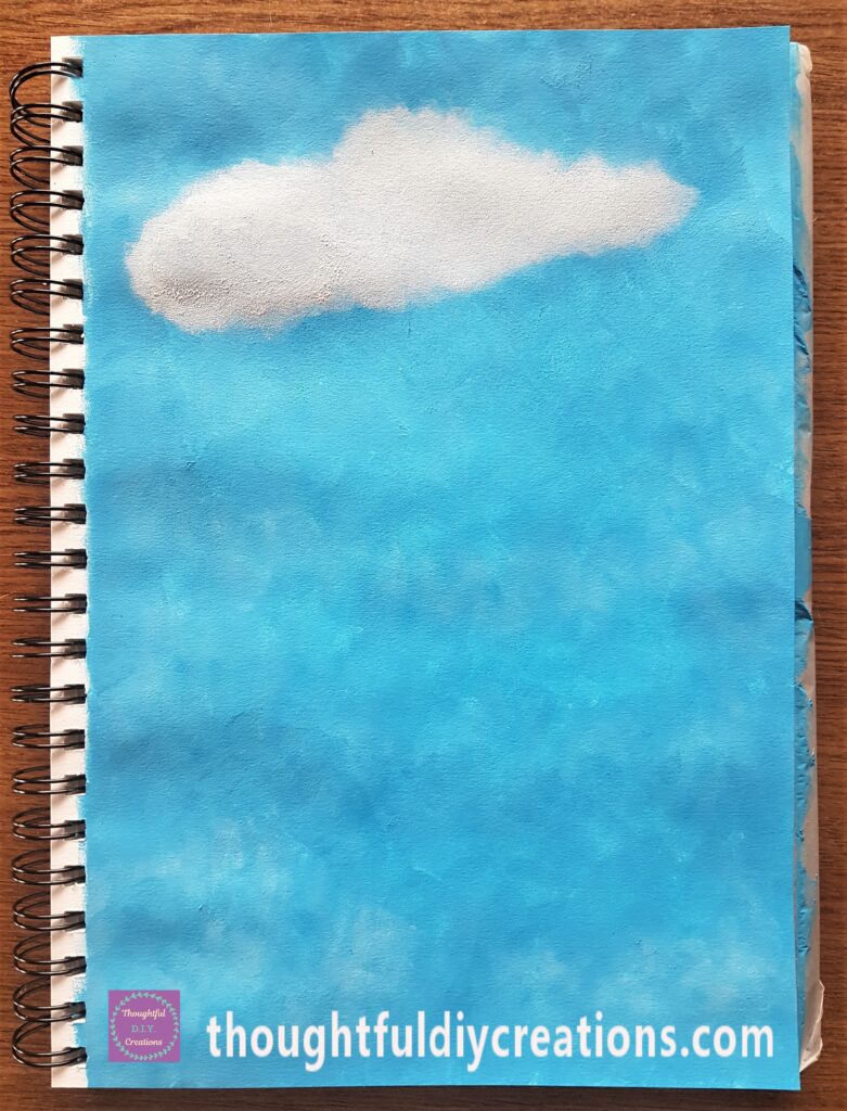 Big Cloud on the top of the Page with white paint and a make-up sponge.