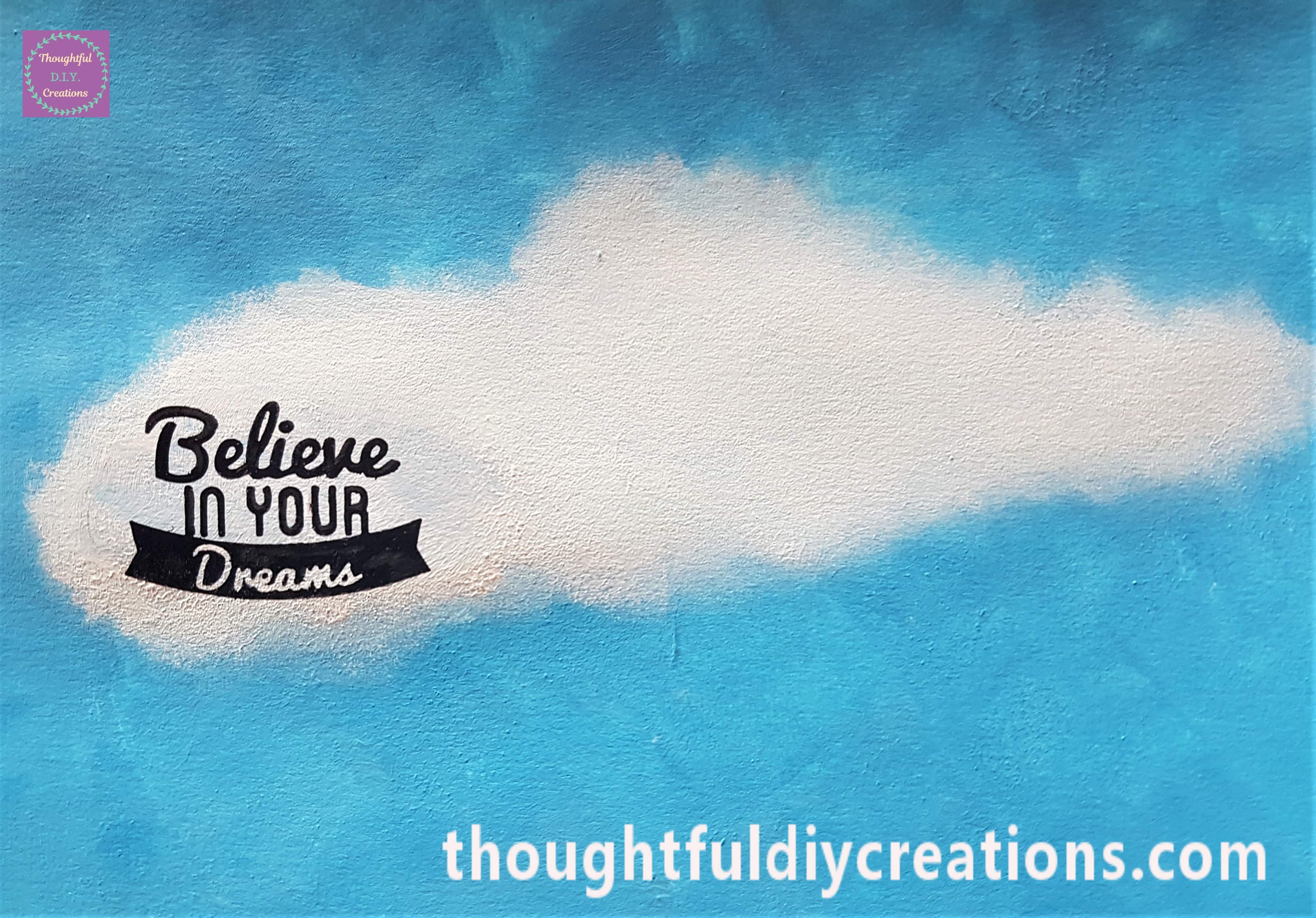 I pressed the stamp into the ink and then held the stamp onto the cloud on the art journal page.