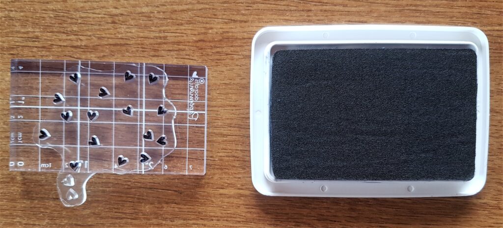 Cluster of Small Love Hearts Stamp attached to the bigger Acrylic Block and pressed into Ink.