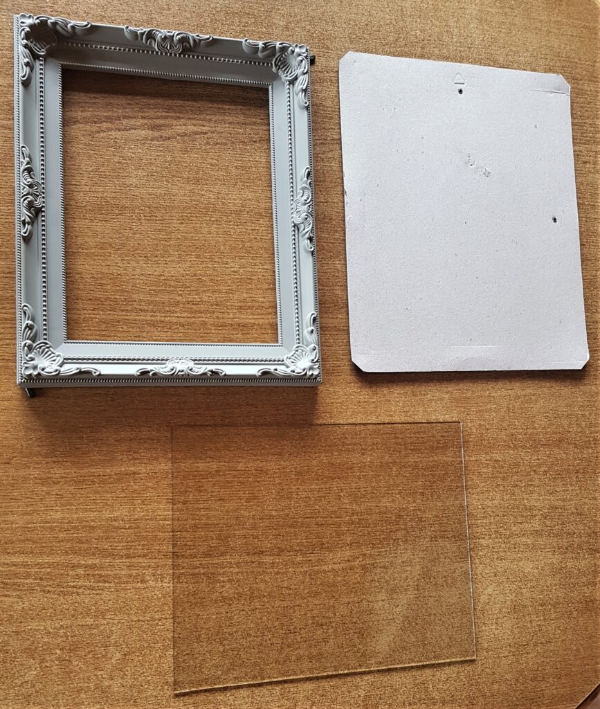 Frame opened up, backing board and glass removed.