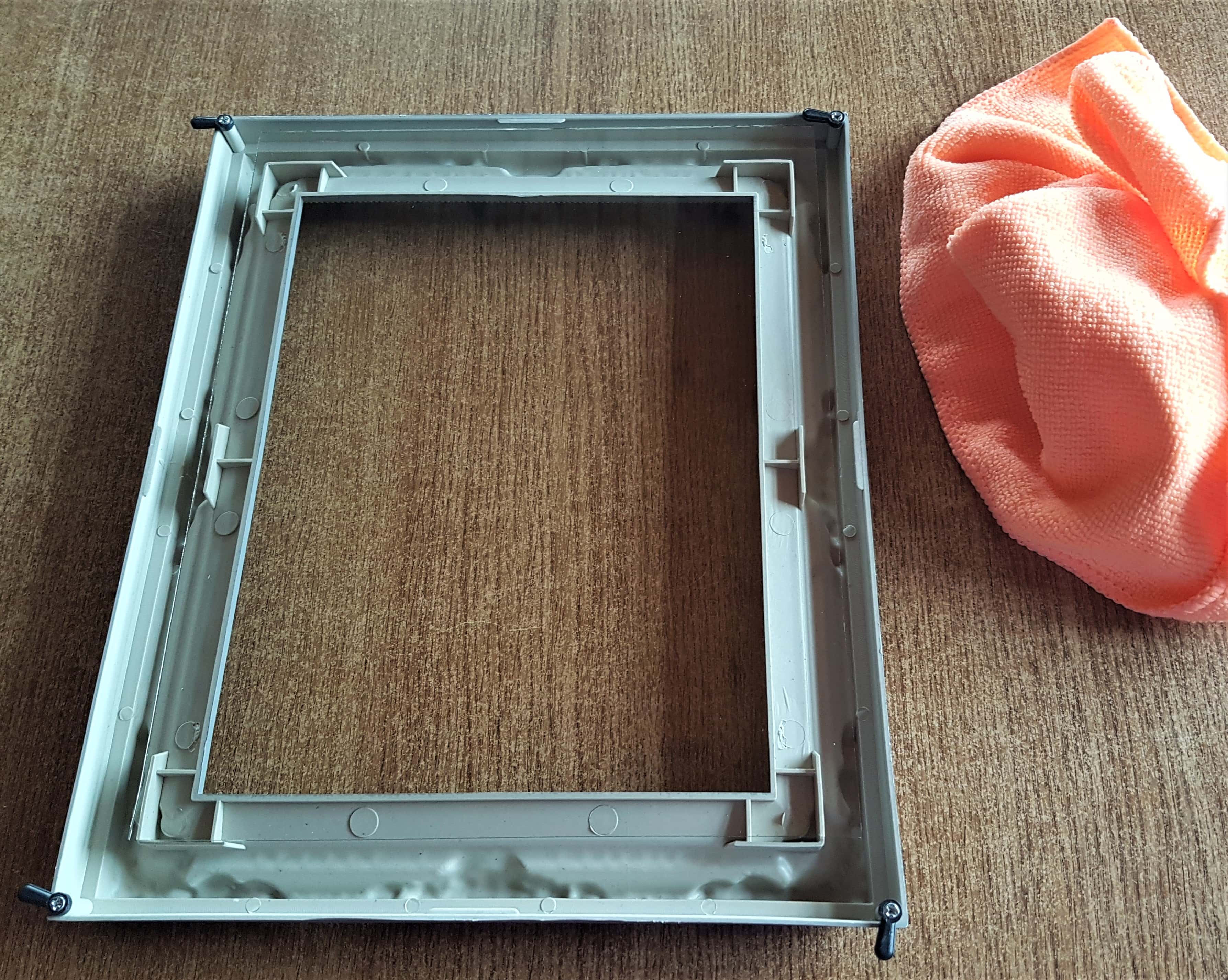 Cleaned the front and back of the Glass insert with a dry cloth and placed it back into the frame.