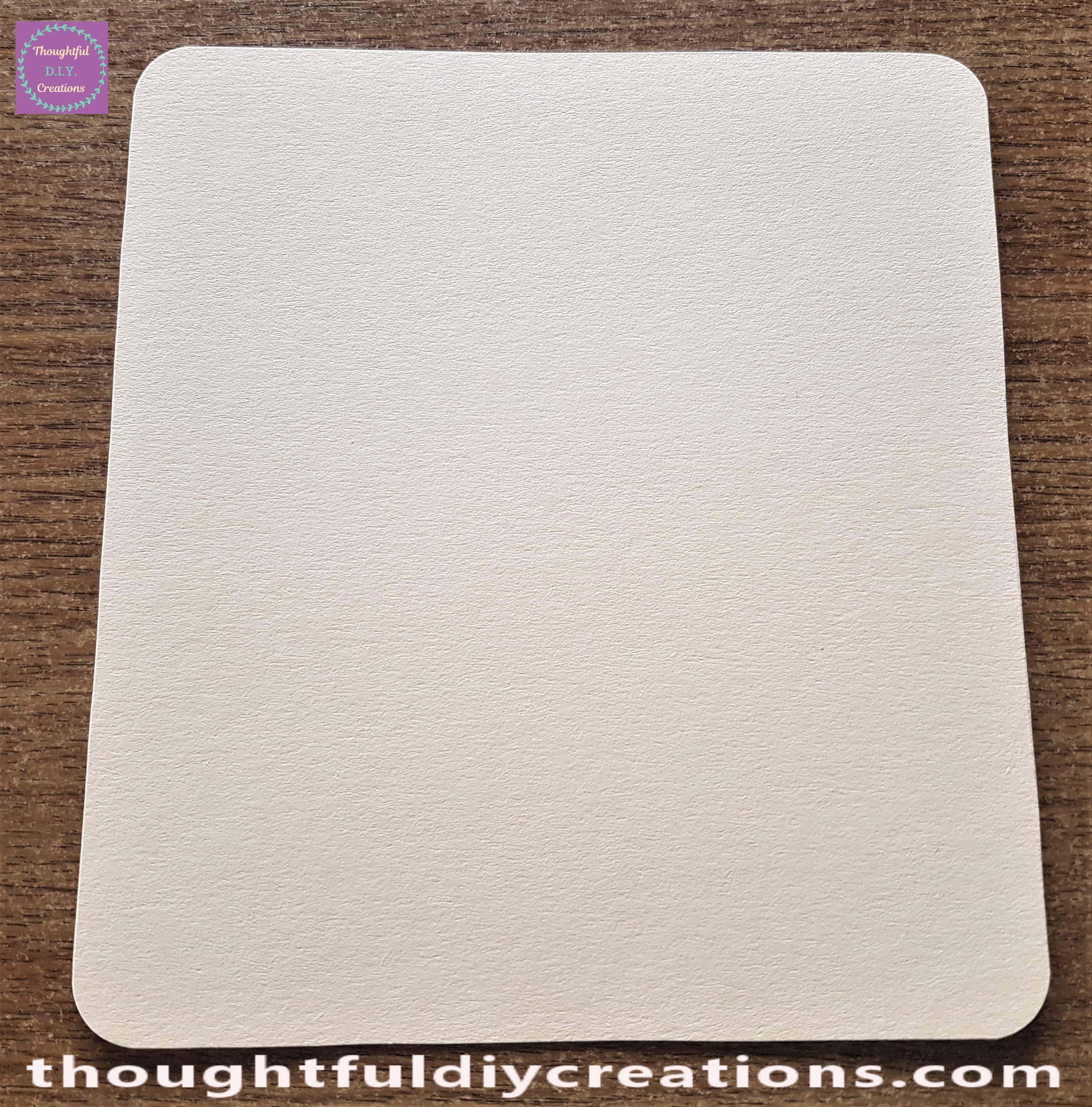 Each of the four corners of the Peach card removed evenly by the Corner Rounder Punch.