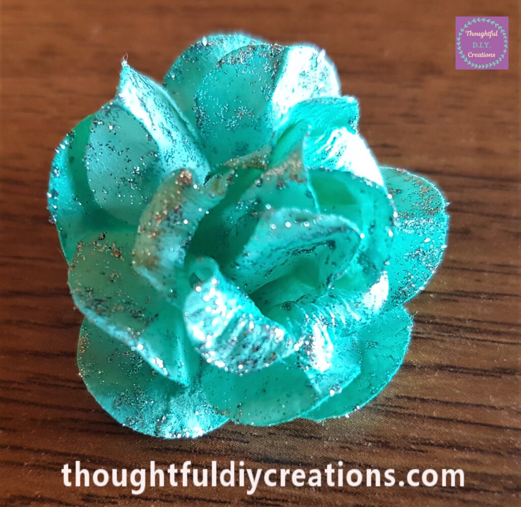 Glitter Eyeliner applied liberally all over the Green flower.