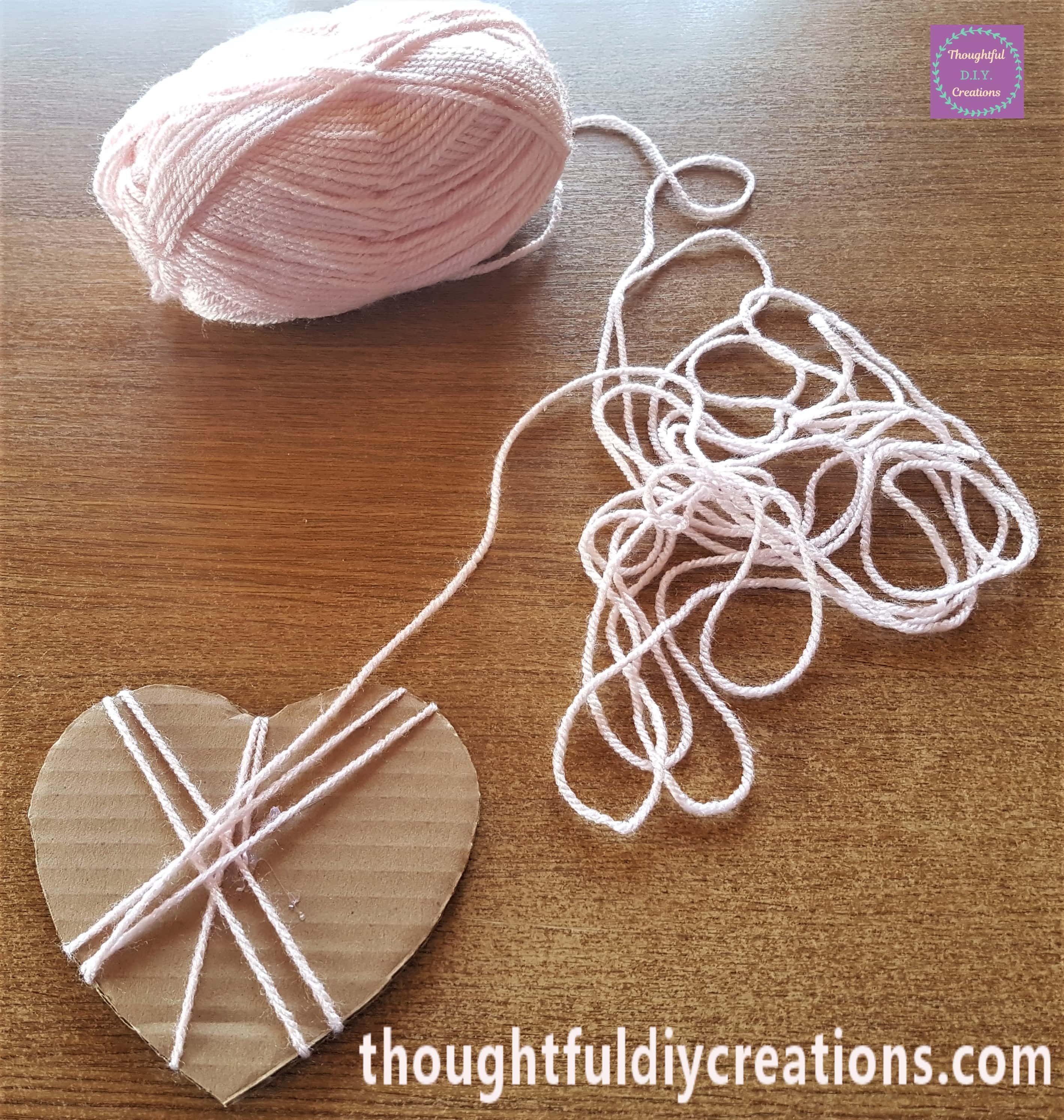 I started to wrap the wool around the cardboard heart.