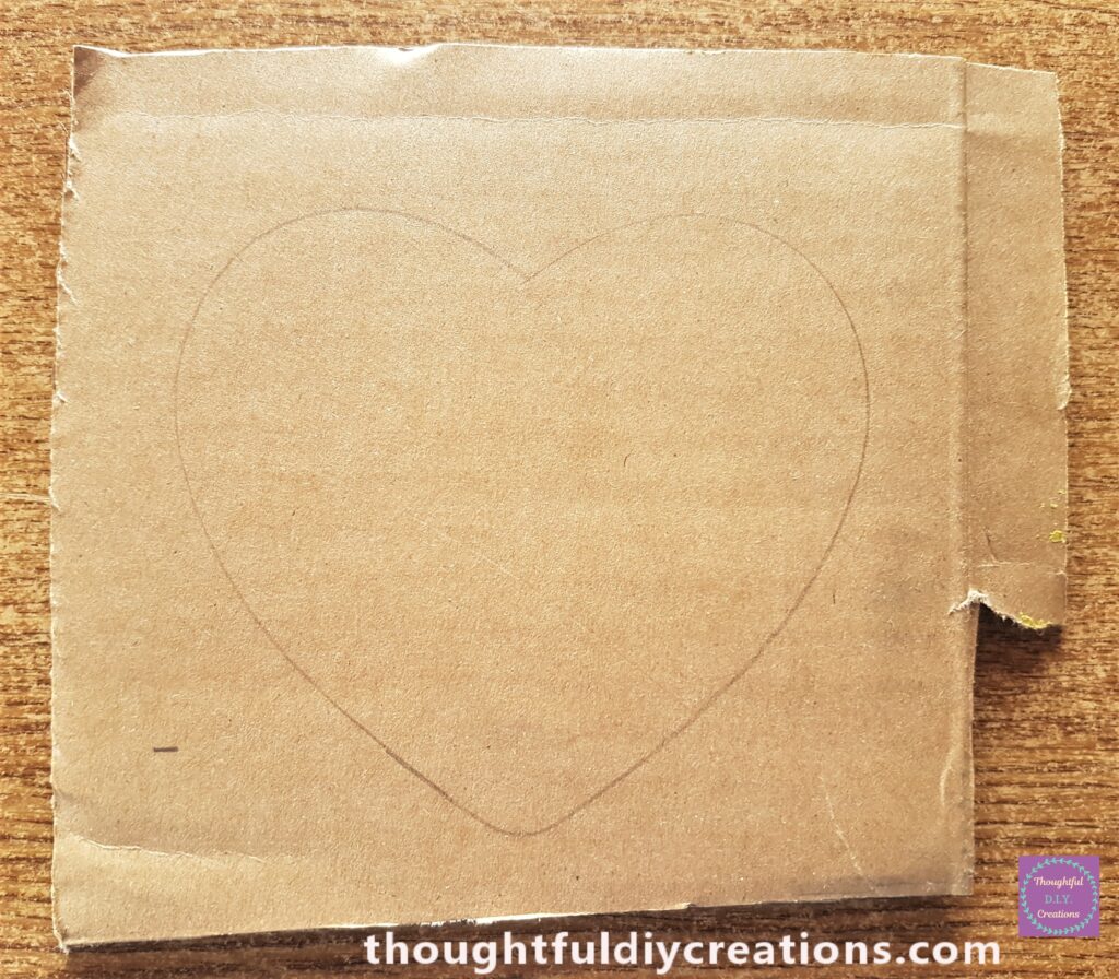 The third Size love heart traced around onto the cardboard using a pencil.