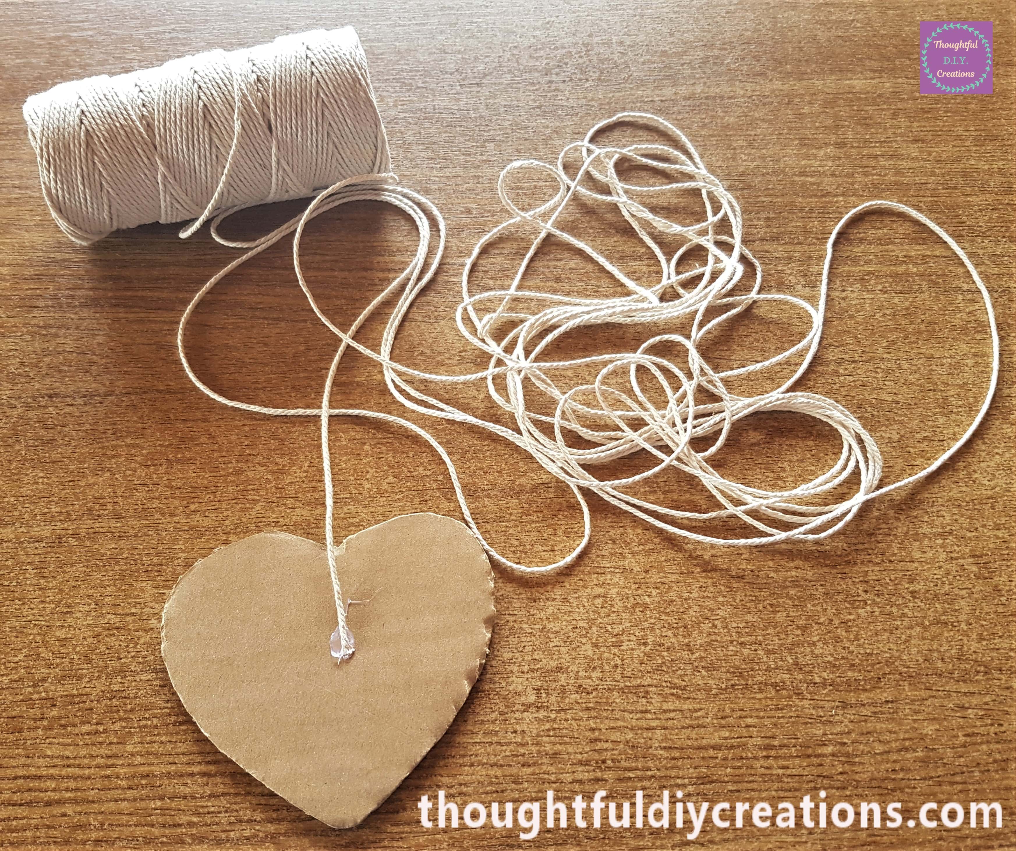 Dab of Clear Hot Glue on the Heart and attached the cream string to it.