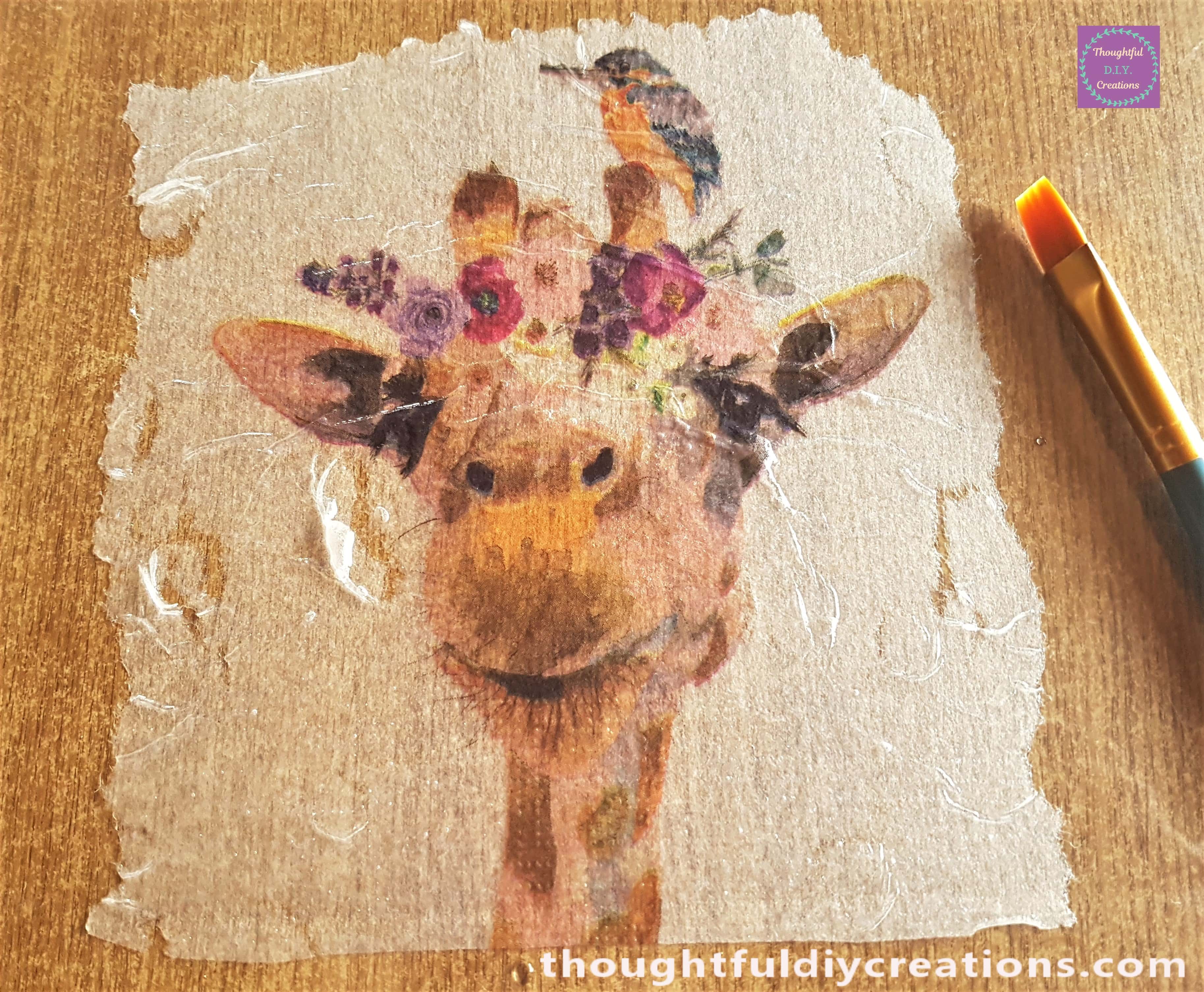 Small, dry, flat paintbrush to brush the wrinkles from the napkin starting in the mid-section brushing outwards.