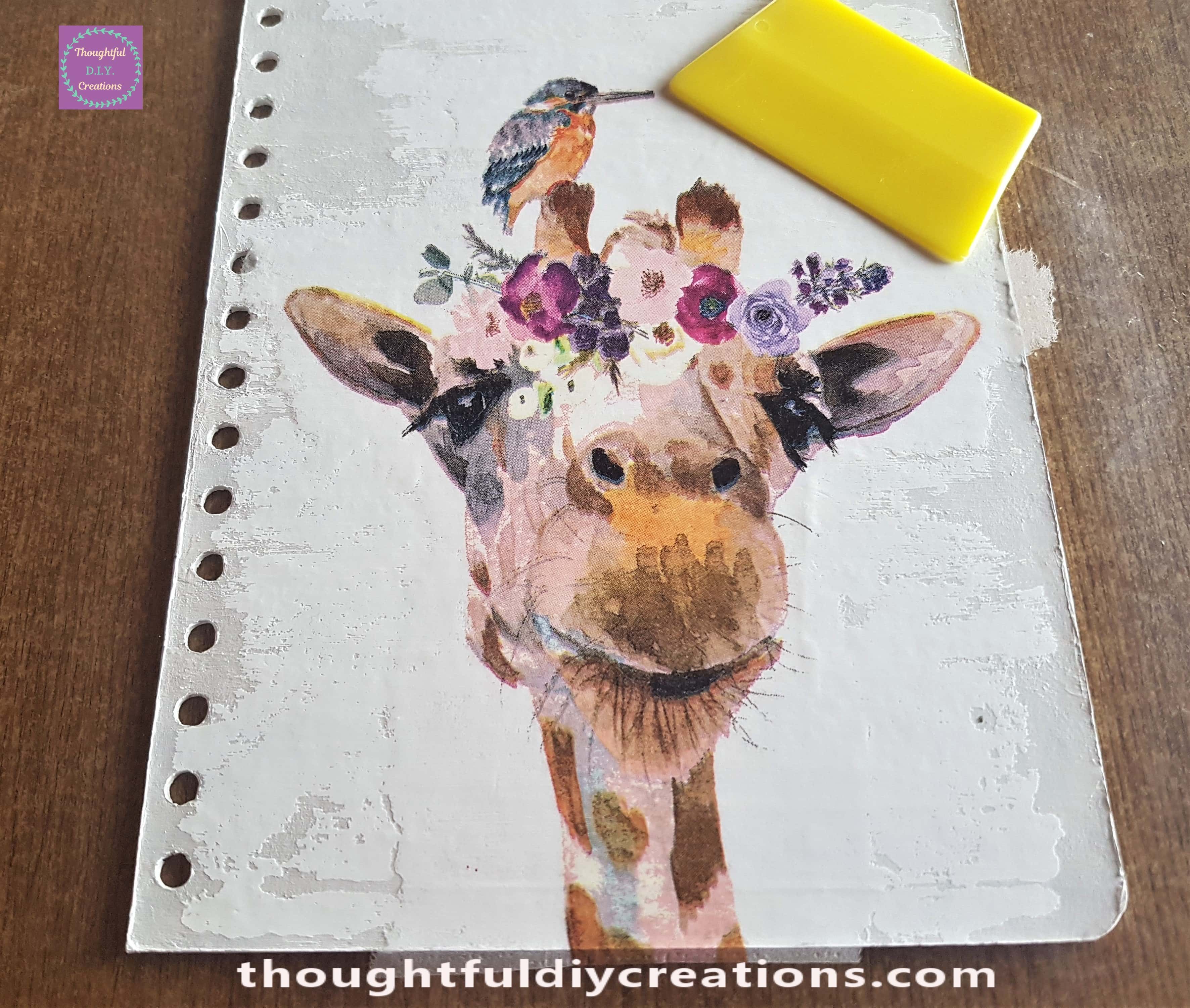 Flat Plastic Card and pressed on the Plastic Sheet over the Decoupage Napkin, from the mid-section outwards to remove air bubbles, excess water and attaching to the Journal Cover.