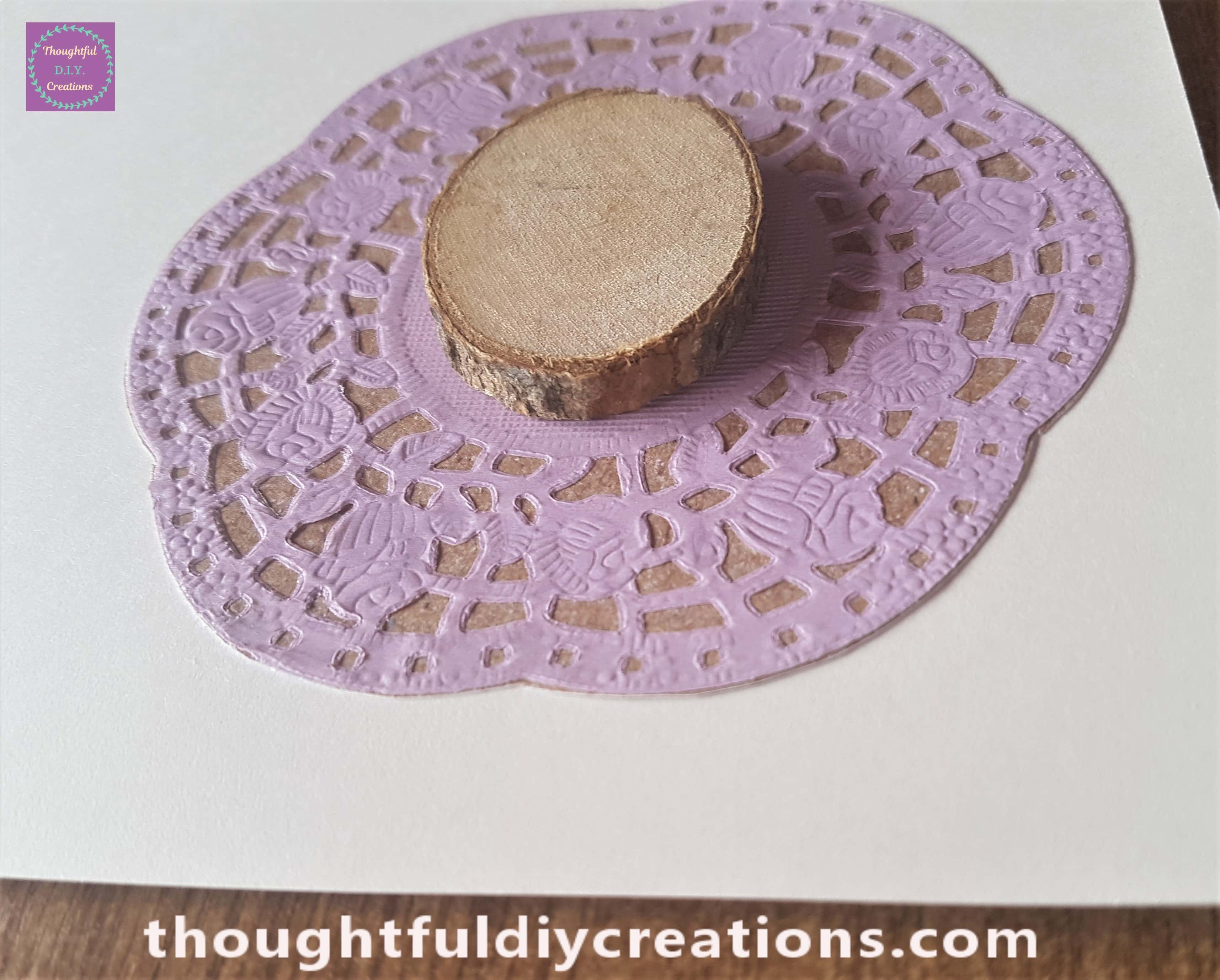 Attached to the mid-section of the Doily.