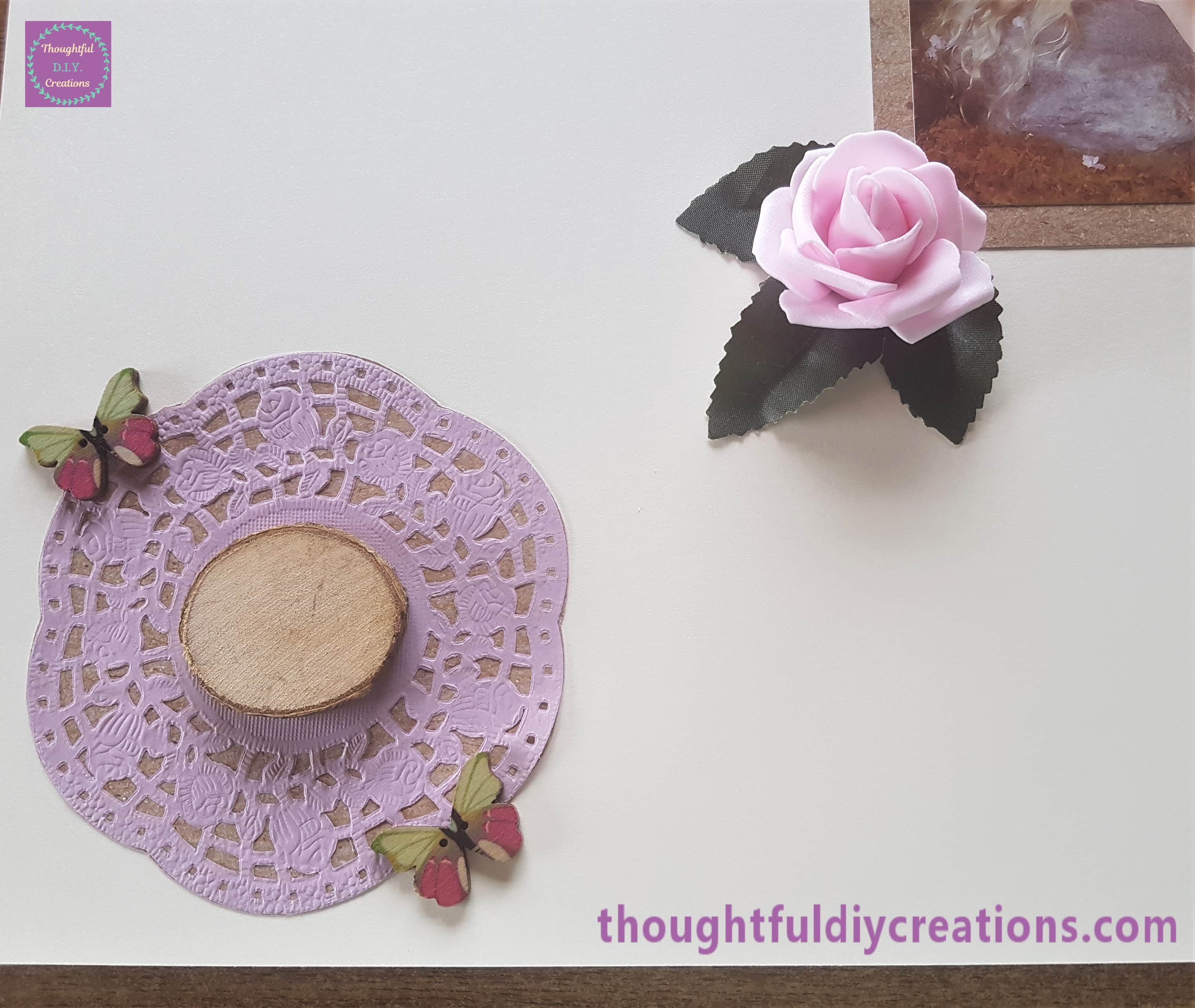 2 of the same design butterfly attached to the top and bottom of the Doily.