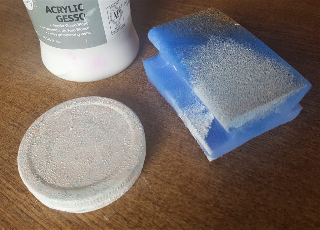 Acrylic Gesso added to the lid of the jar using the sponge to prime it.