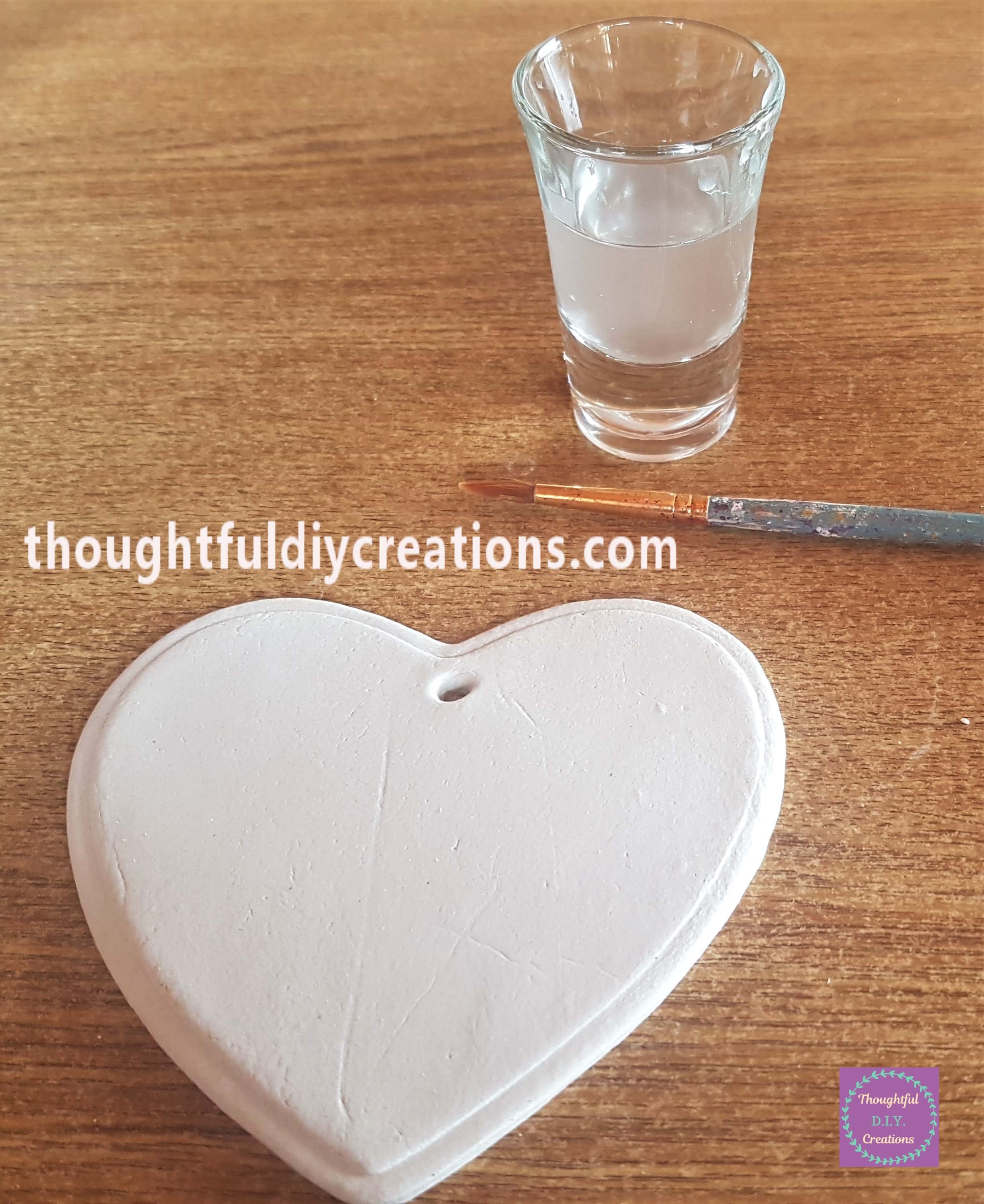 I put some water into a small glass and got a paintbrush.