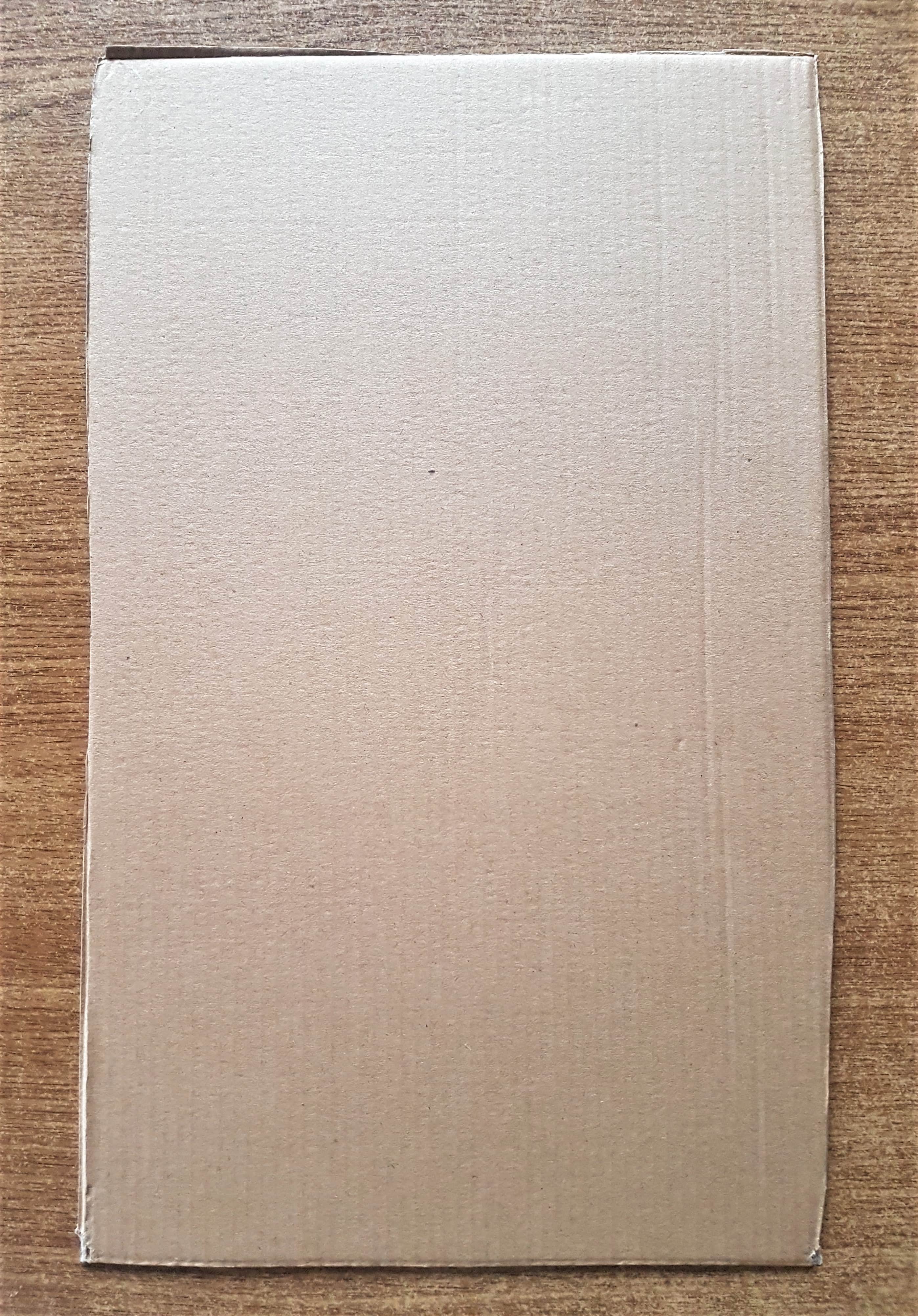 I cut out the side of a cardboard box using a strong scissors.