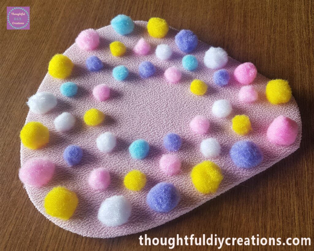 I added another layer of medium size pom poms.