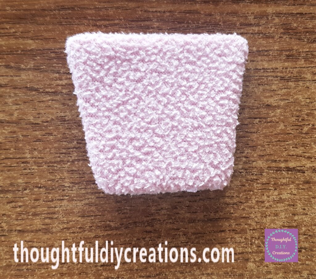 Hot Glue along each side of the cardboard and attached the fleece.