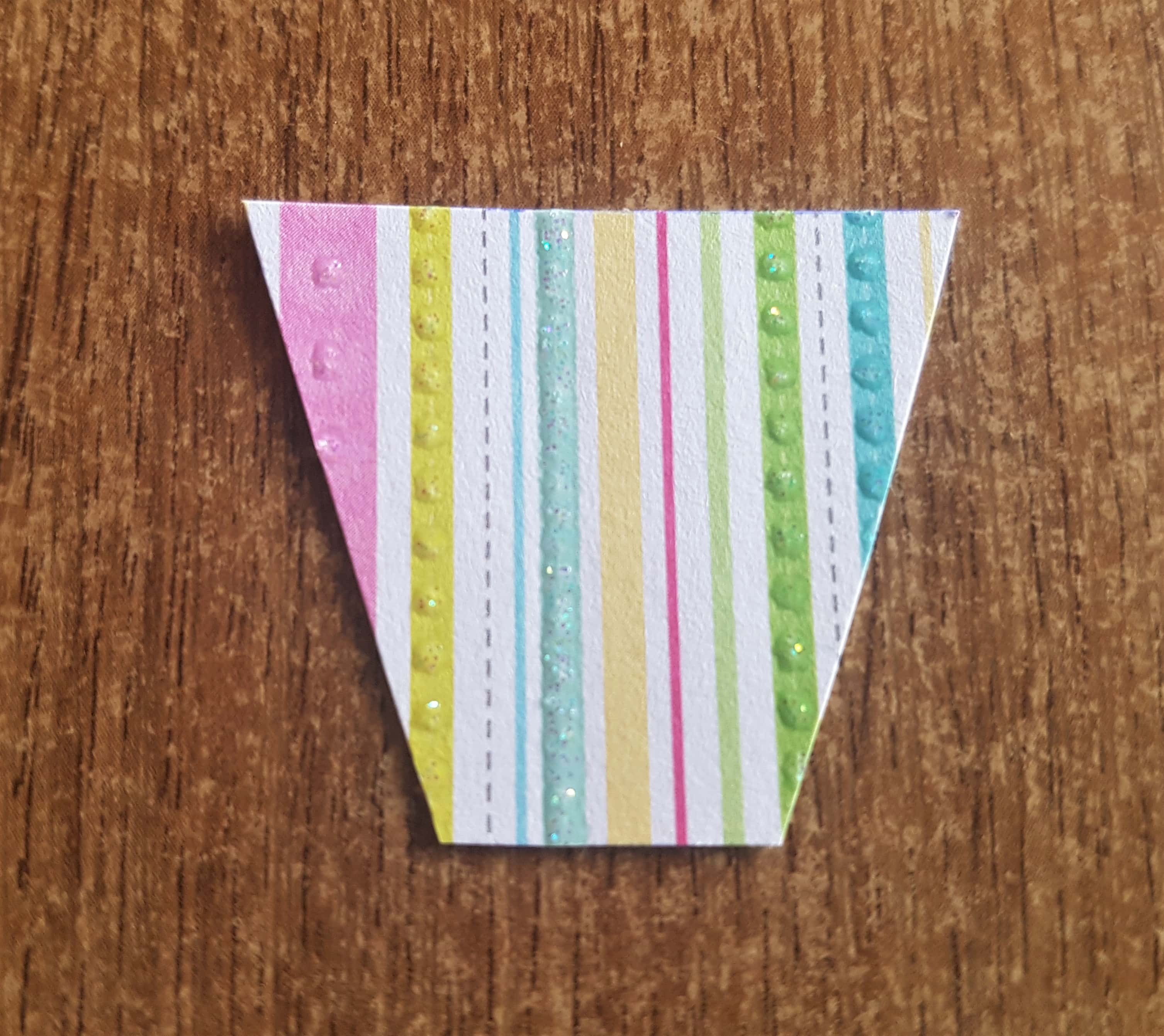 I cut a section of multi-coloured striped cardstock smaller than the basket.