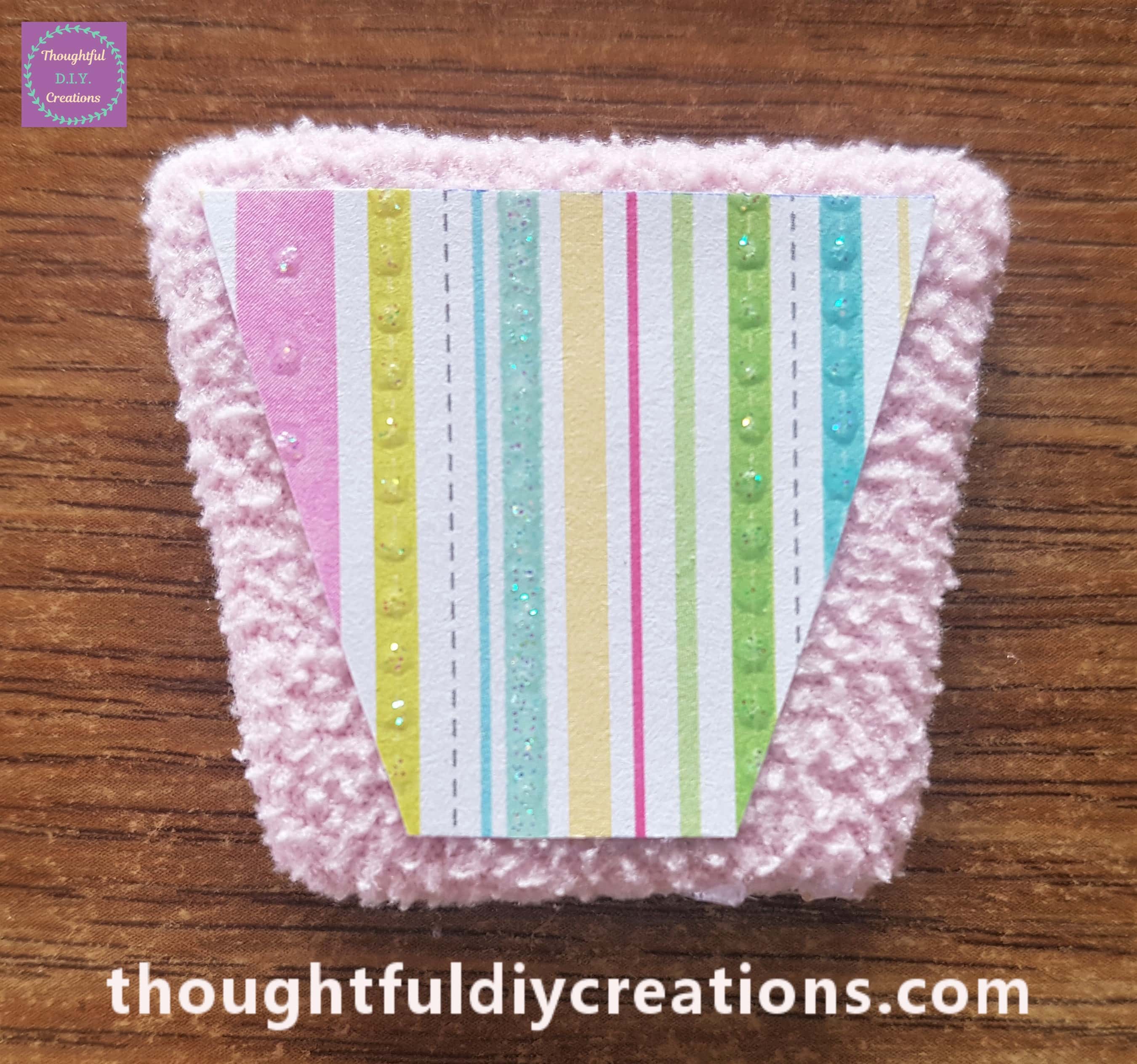 Attached to the fleece basket using PVA Glue and a paintbrush.