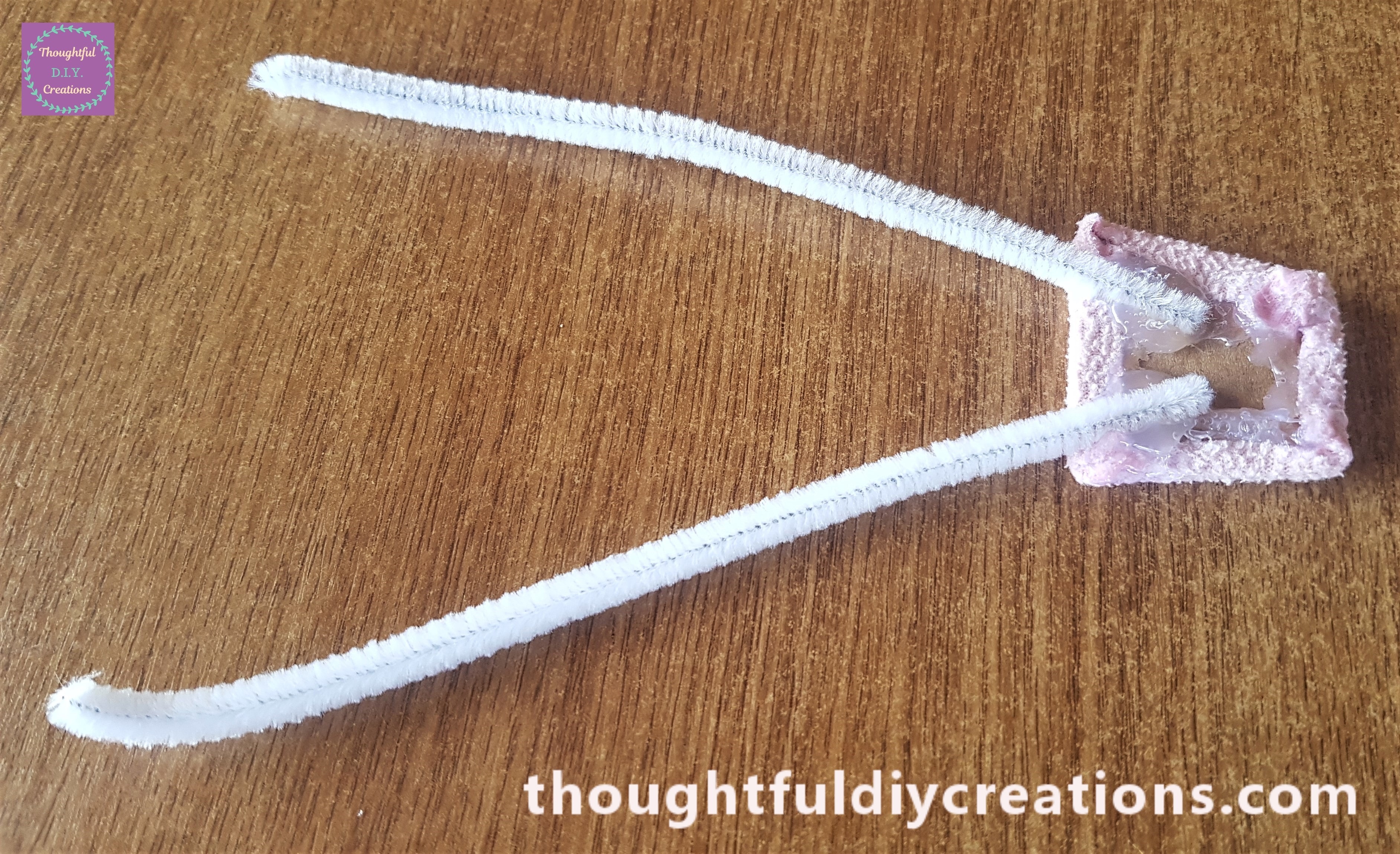 I cut the Pipe Cleaner in half and hot glued each one to the basket.