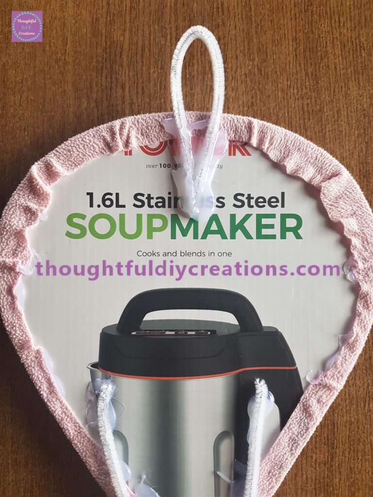 Hot glued the 2 ends together and attached to the back of the hot air balloon. Generous amount of hot glue added to give stability.