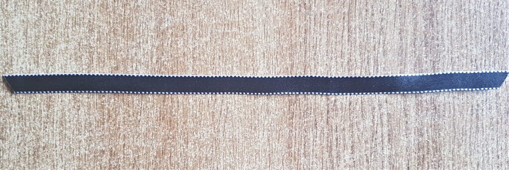 Black Ribbon with Silver border detail.