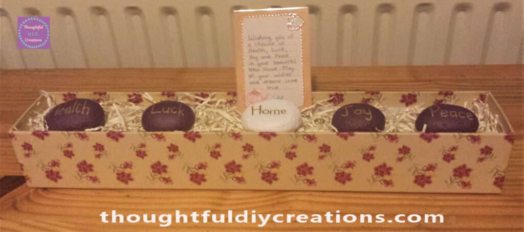I painted 4 of the Stones Purple and the Home Stone White. All the Font was done with a Gold Paint Pen. I displayed the Stones in a decorative box filled with raffia and laminated a Greeting.