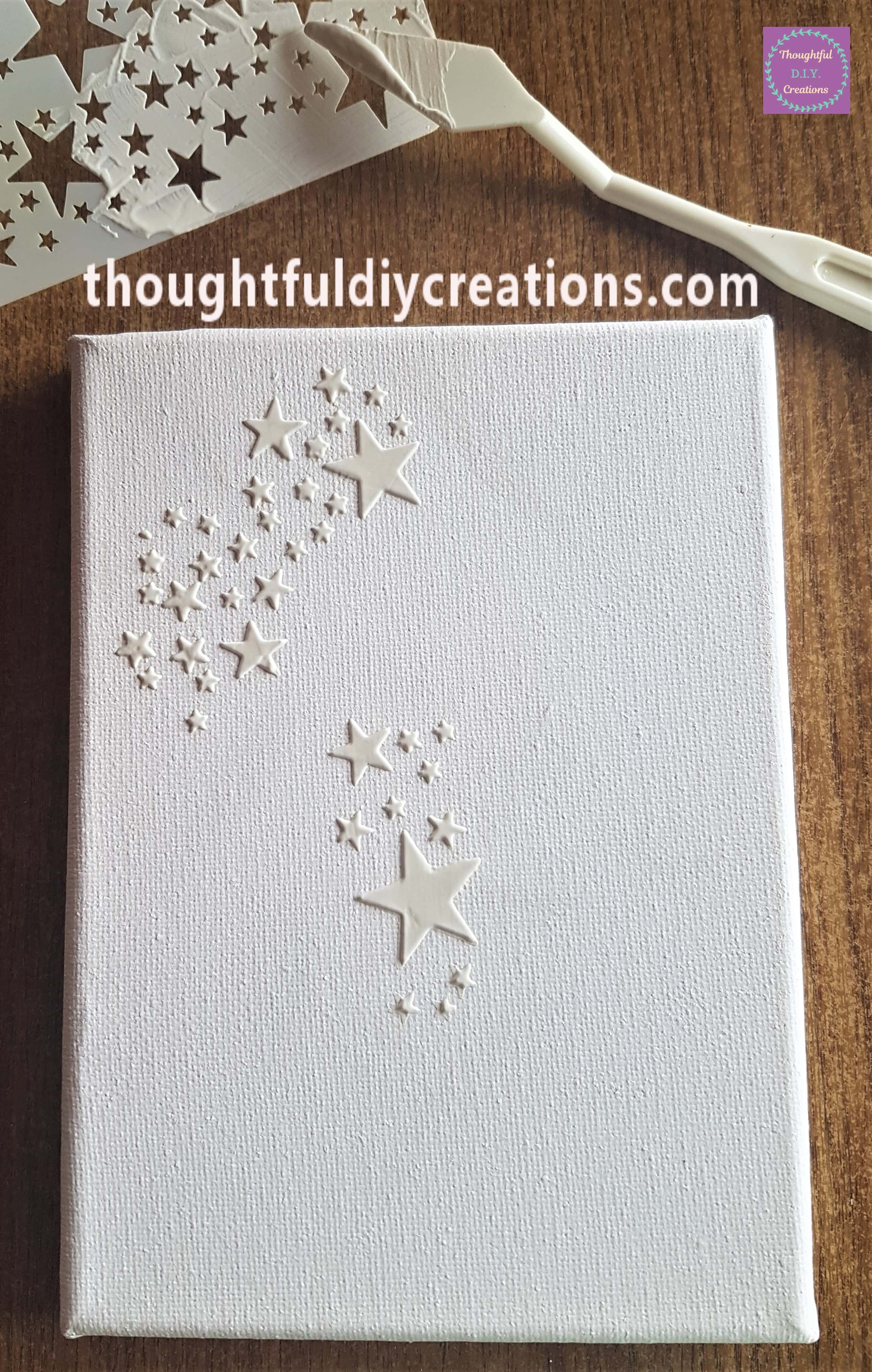 Stencil on top left half of the canvas, added more stars with the palette knife and modeling paste.