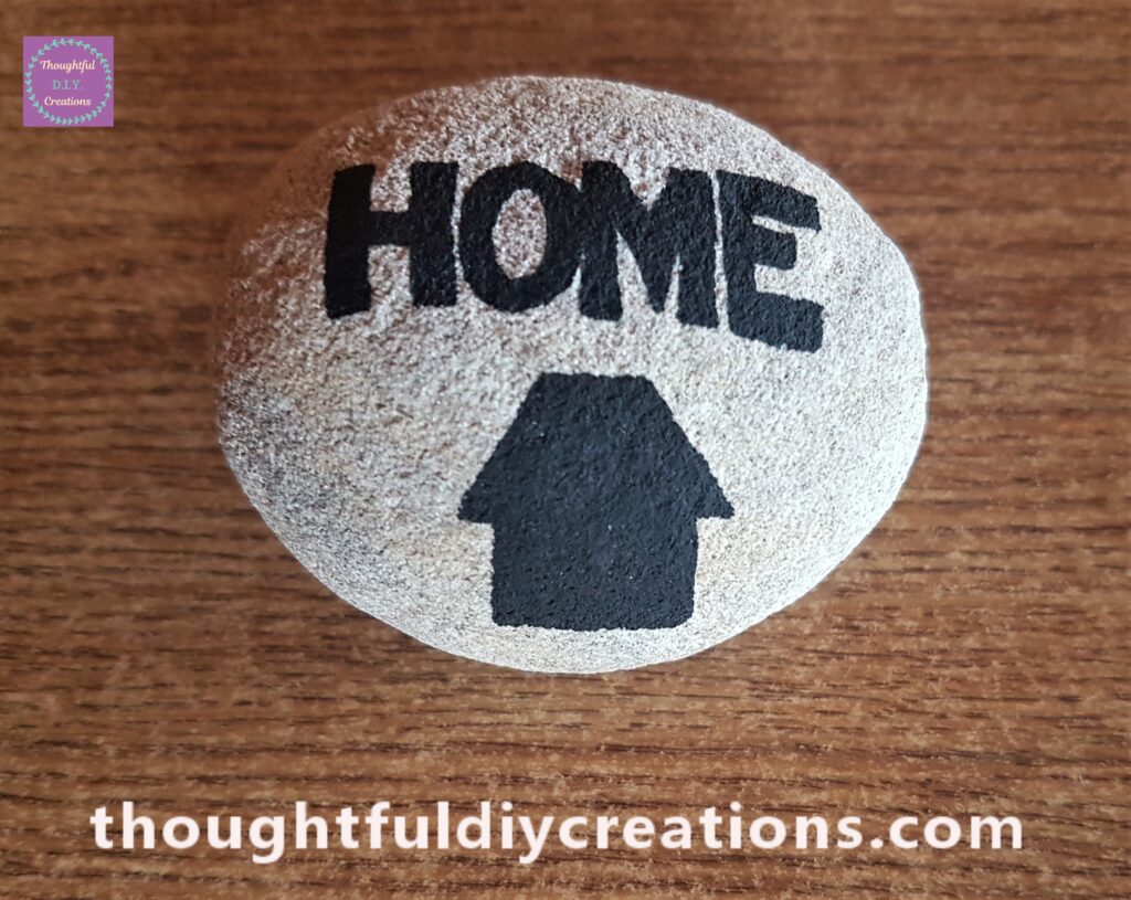 I drew a House Silhouette onto the biggest Stone and filled it in with the Black Paint Pen.