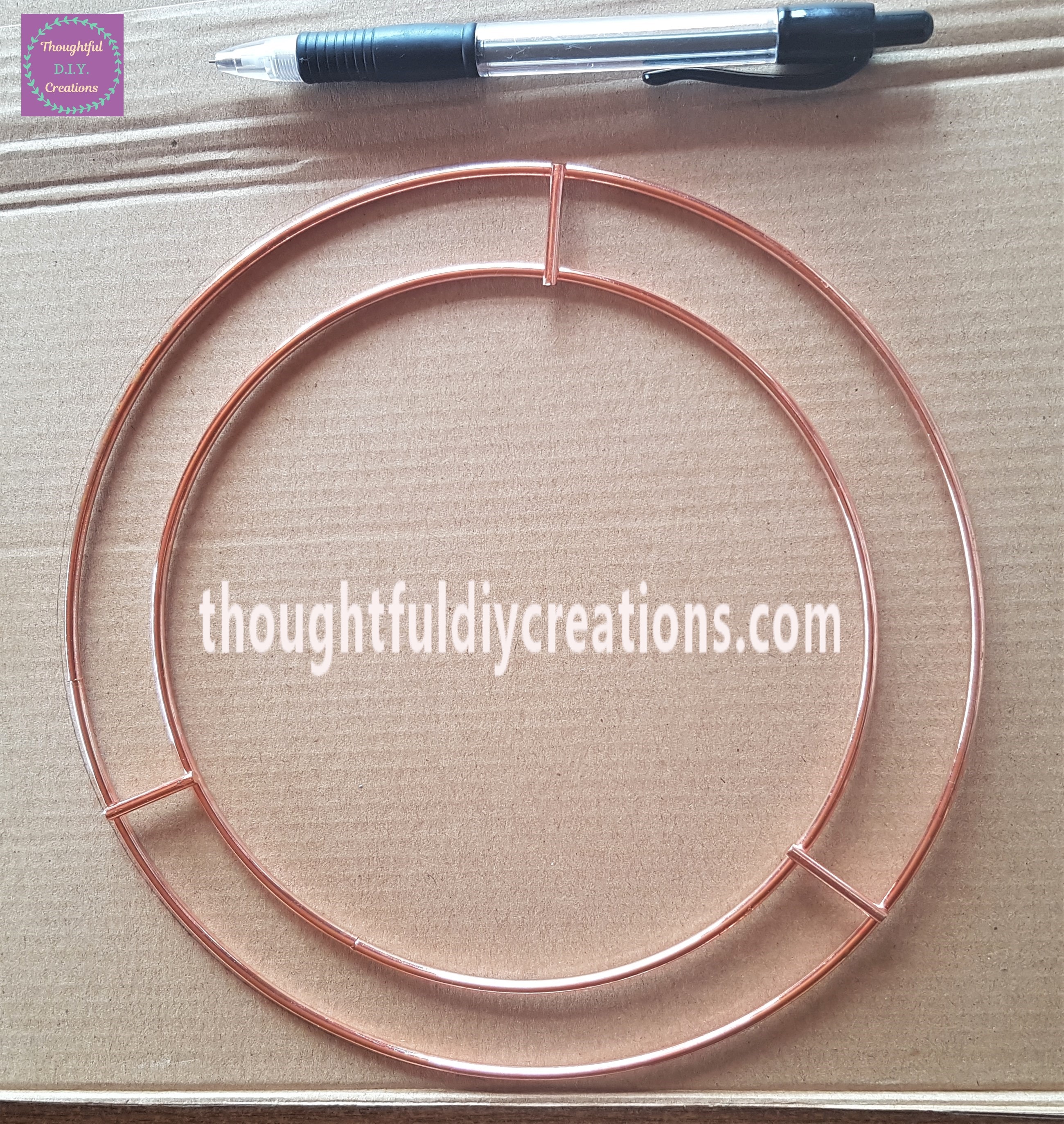 I put the Wire Wreath on top of the Cardboard and drew around the outer circle with a pencil.