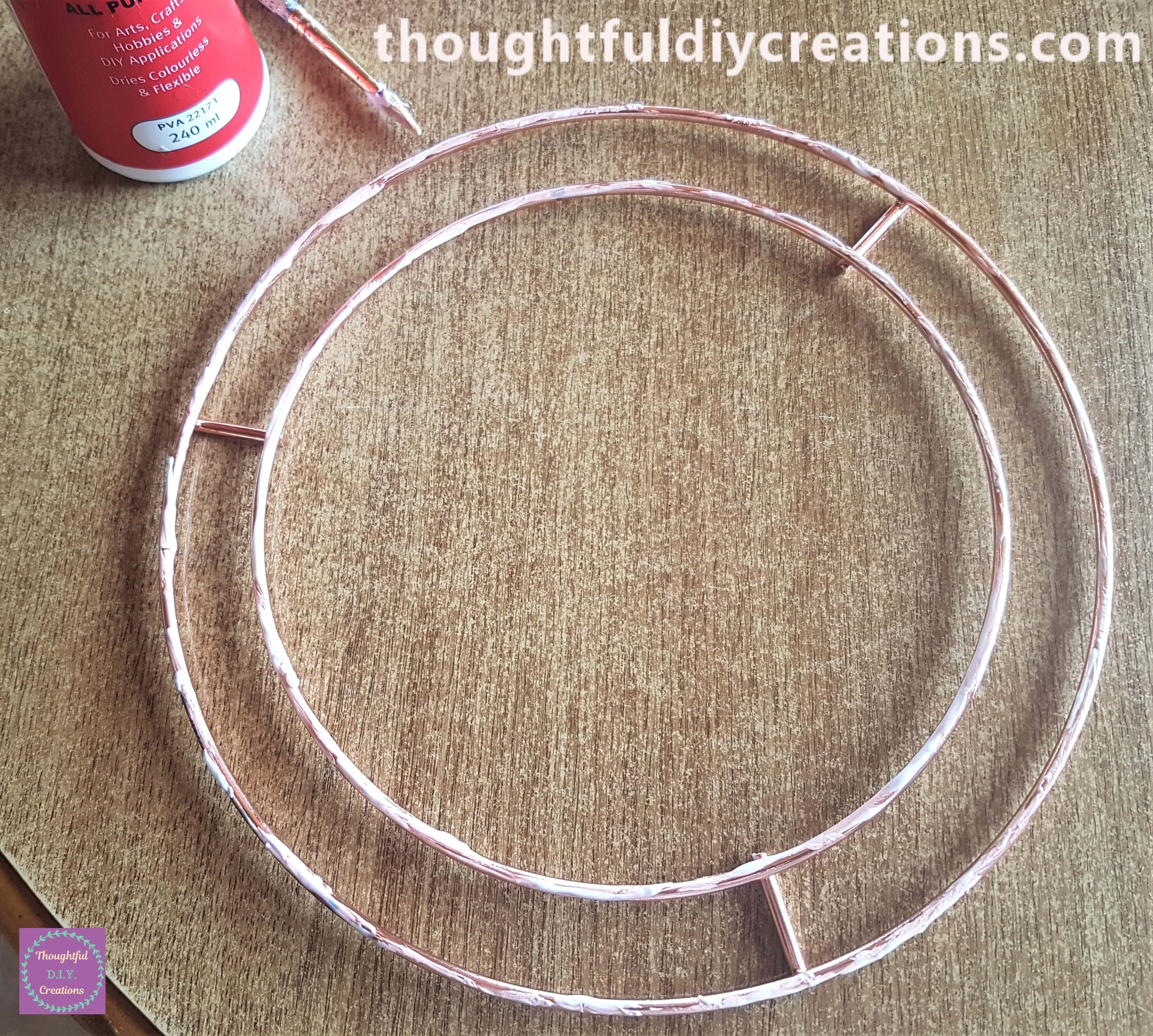 I put PVA Glue around the circles of the Wire Wreath using a paintbrush.